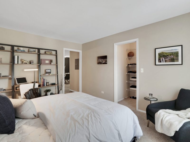 This image shows an upgraded bedroom area with modern lighting and oversized closets with built-in organizers.