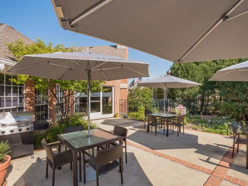 This image shows the ideal outdoor balcony with a dining table, sitting areas, and a bbq grill.